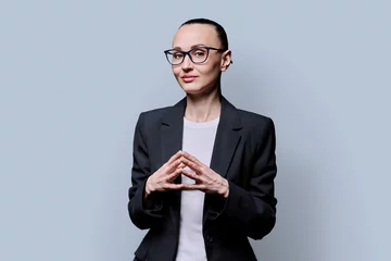 Foto op Plexiglas Portrait of thinking serious confident business woman , on grey studio background © Valerii Honcharuk