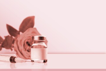 Syringe and vial in pink background.  concept of injections.