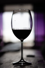 Silhouette of a glass with some red wine.