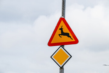 Road sign warning for deer crossing.