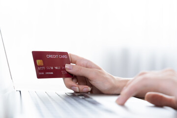 Close up credit card using for online payment, banking and shopping on the internet network with laptop computer showing credit card technology for online secured wallet top up and utmost purchase