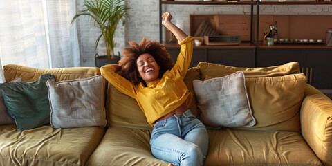 Obraz premium Relaxed young woman new homeowner stretching body on stylish comfortable couch in home interior, smiling, laughing, enjoying leisure, celebrating real estate buying