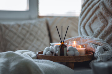 Cozy corner for home meditation, relaxation, detention. Aroma reed diffuser, aromatic burning...