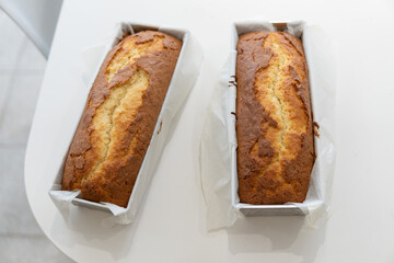 two golden biscuits inside their molds with kitchen paper on a white table with copy space