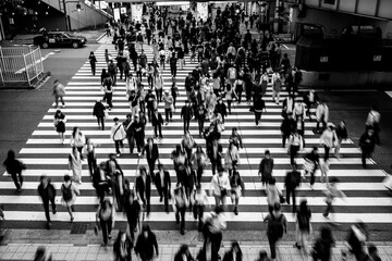 大阪梅田の繁華街で横断歩道を渡る人々。モノクロでブらせて撮影