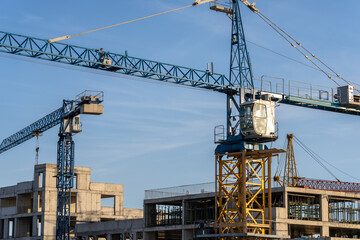 Construction of high-rise buildings, crane next to buildings, construction concept