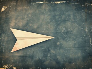 White origami plane on a marbled blue textured backdrop.