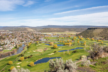 City of Prineville in Oregon, buildings and golf field with ponds, viewing from above