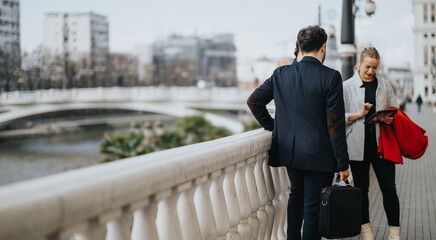 Dynamic young professionals engaged in a business discussion outdoor, analyzing market trends and strategies for profit growth.