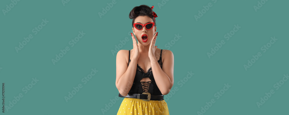 Sticker Shocked young pin-up woman in sunglasses on green background