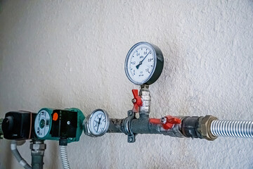 Water supply and heating pipes with pressure sensors and manometers.