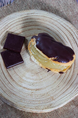 French Delight: Éclair puff pastry overflowing with cream and rich chocolate
