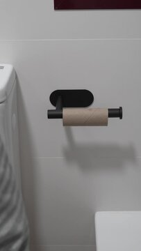 Last Roll Woes. Unrecognizable man laments last piece, highlighting hygiene hassle and frustration. Toilet paper trouble