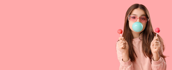 Trendy girl with lollipops blowing bubble gum on pink background