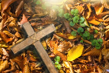 Wooden christian Cross with autumn leaf
