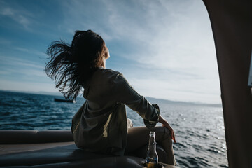 Fototapeta premium A happy girl feels the joy of a peaceful boat ride, the wind in her hair reflecting a sense of freedom.