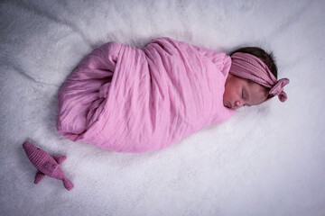 Newborn baby girl sleep on pink blanke, perfect model babe, pink shark doll around, GIF
