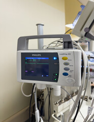 Hospital monitor displays vital signs in ICU, reflecting science and healthcare urgency