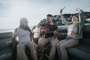 Three friends share a joyful moment playing guitar and taking selfies on a boat, basking in the...