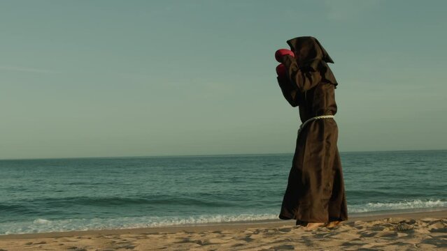 Fighting Athlete Monk Does Boxing On The Beach