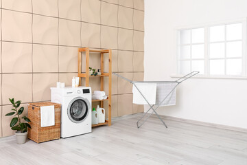 Interior of room with laundry basket, washing machine and dryer