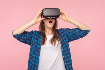 Portrait of shocked surprised woman in vr headset, playing virtual reality game with open mouth,...