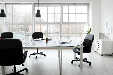 Interior of office with table prepared for business meeting