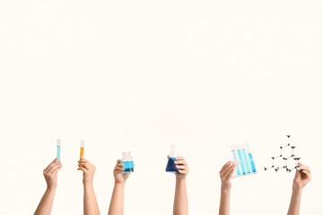 Female hands holding filled flask with bottle, test tubes and molecular model on white background....