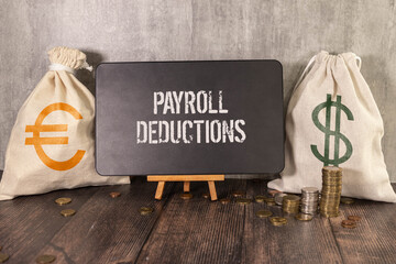 Selective focus. Calculator,pencil and banknotes with the word Payroll Deduction