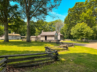 Obraz premium Split Rail Fence and Log Cabin Style Homes at Lincoln's New Salem State Historic Site. A reconstruction of the former village where Abraham Lincoln lived 1831 to 1837. Public park on public land.