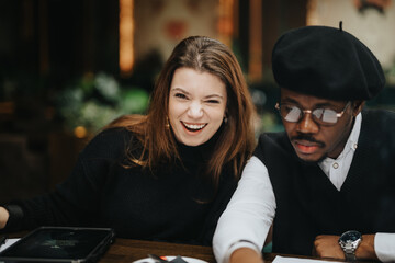 A smiling woman and a focused man wearing a beret collaborate in a productive and light-hearted business setting, portraying teamwork and diversity.