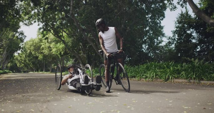 Man, paraplegic and riding tricycle in park, forest or road for fitness, health and wellness. Young people, friends and bike ride of person with a disability in workout, training or outdoor exercise