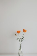 Obraz premium Three Orange Flowers in Clear Vase