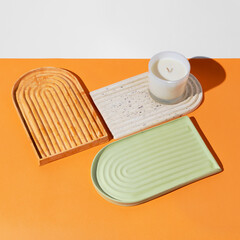 Podium for cosmetic product presentation. Abstract minimal geometrical form on orange background