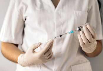 nurse injecting vaccine into a syringe