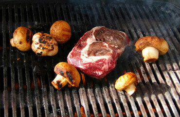  Rib eye steak and mushrooms on the grill