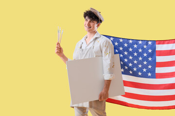 Male artist with USA flag and blank poster on yellow background