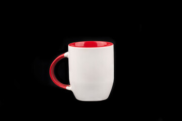 Red and white mug isolated on black background 