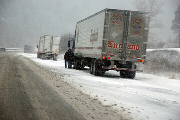Large trucks fight a winter storm