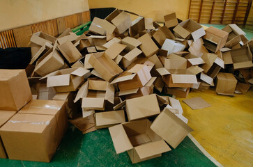 The storage room area is filled with empty cardboard boxes. a large group of used cardboard boxes