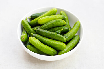 Mini cucumbers on white background.