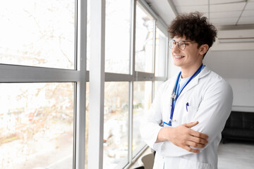 Male medical intern near window in clinic