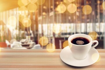 Wooden table at coffee shop with a cup