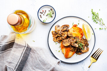 French breaded chicken breast steak with mushrooms and onion sauce with white wine and thyme on plate, white  table background, top view - 792154490