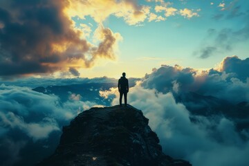 Man Standing on Mountain Peak Under Cloudy Sky