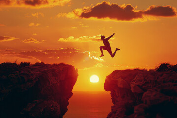Silhouette of man jumping over a gap at sunset, concept business success and achievement