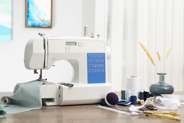 White sewing machine, cloth and craft accessories on wooden table indoors - obrazy, fototapety, plakaty