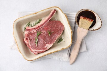Raw meat, rosemary and marinade on light table, top view