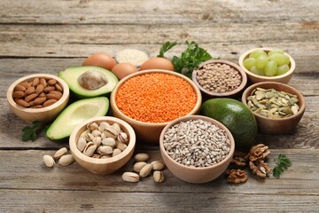 Different products high in natural fats on wooden table