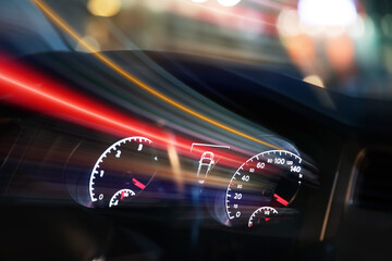 Dashboard with speedometer and tachometer in car, motion blur effect